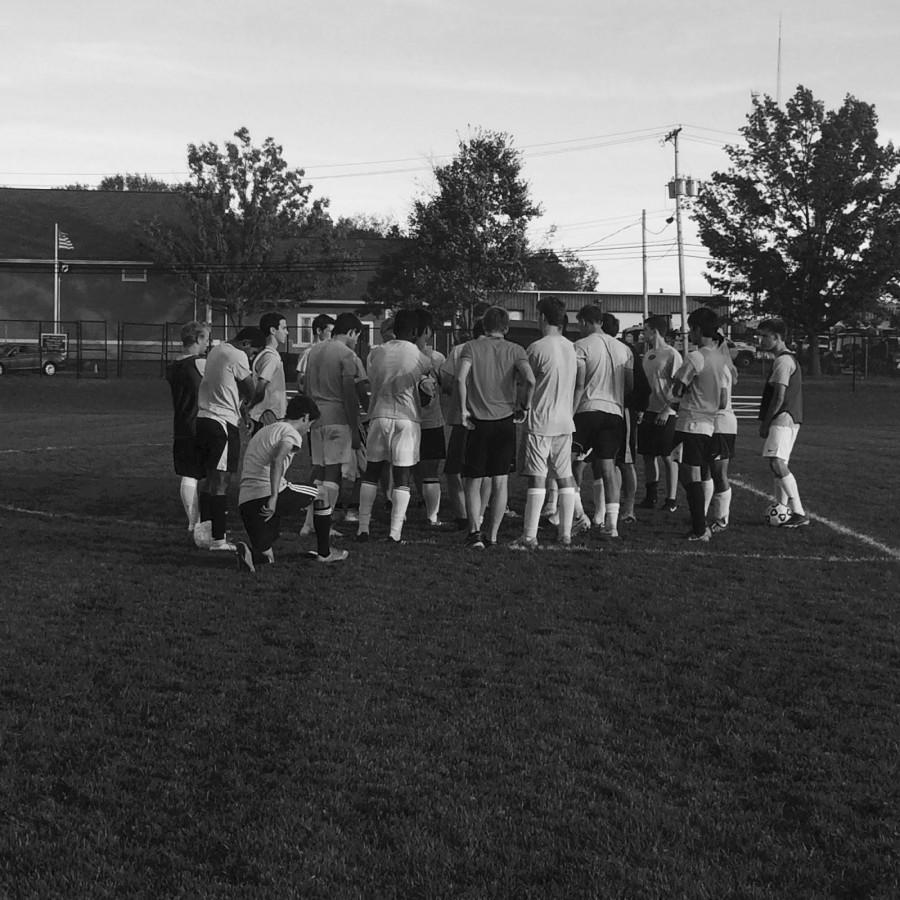 The varsity boys soccer team huddles together after practice. Photographer: Karli Sottung ’15