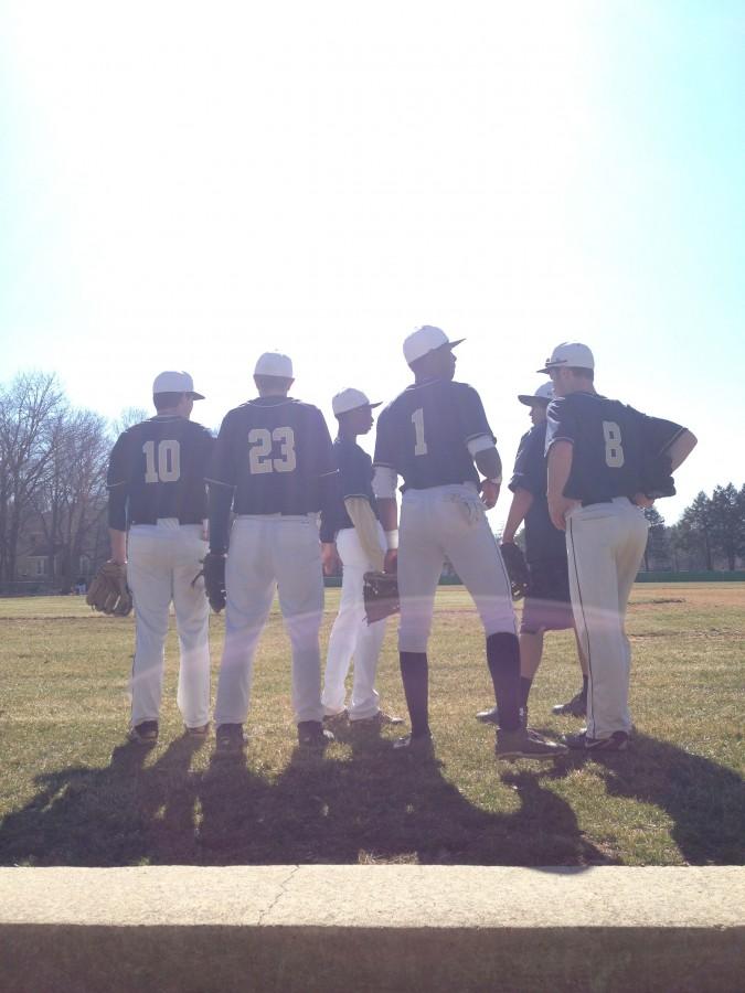 The varsity baseball team gathers before their game against Lawrenceville.