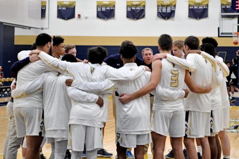 Boys Varsity Basketball in a pre-game huddle.