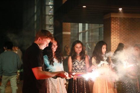 Students light sparklers as per Diwali tradition.